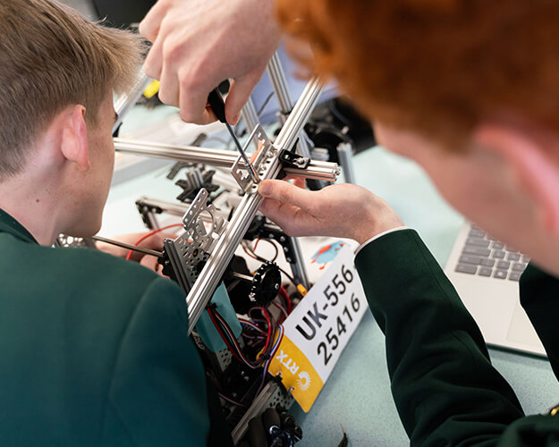 Students building a mechanical object