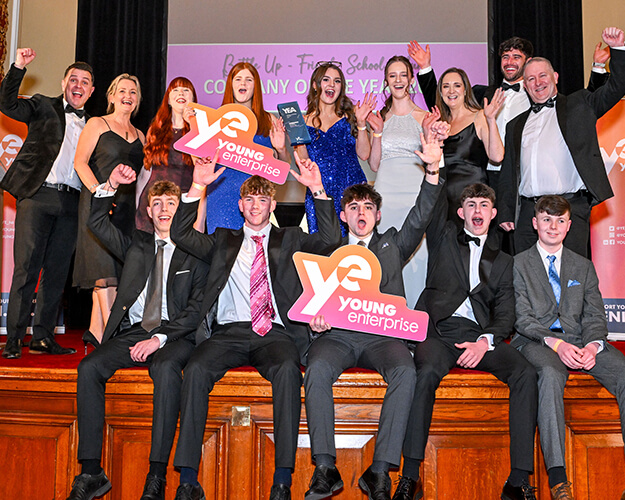 Students holding young enterprise signage