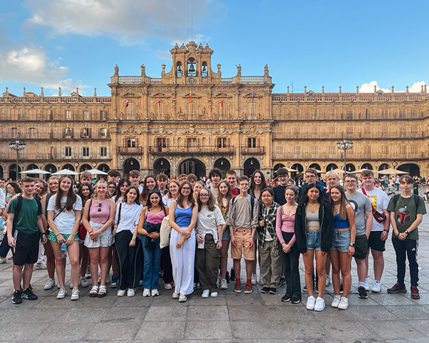 Students congregating outside an old building