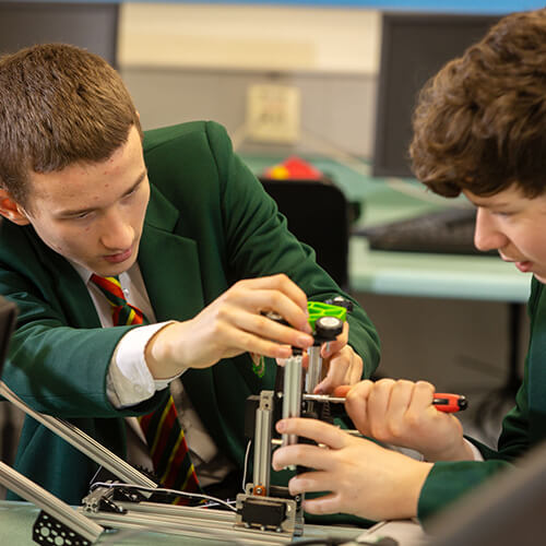 Students building a mechanical object
