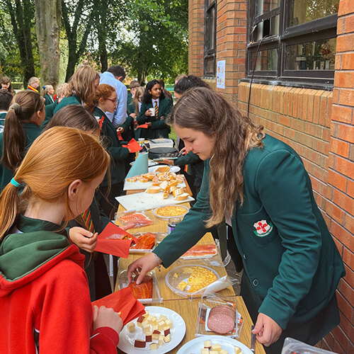 Students outside trying food samples