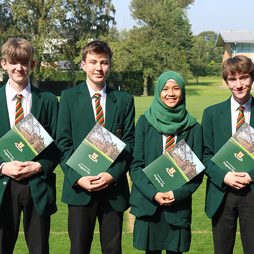 4 students holding a prospective brochure