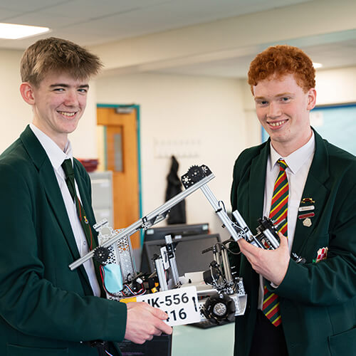 Students holding a robot