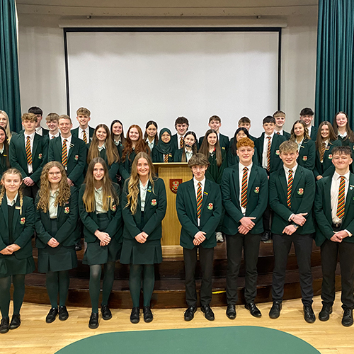 A group of students stood in an assembly hall