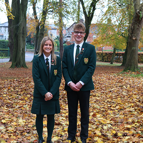 Two students stood on leaves