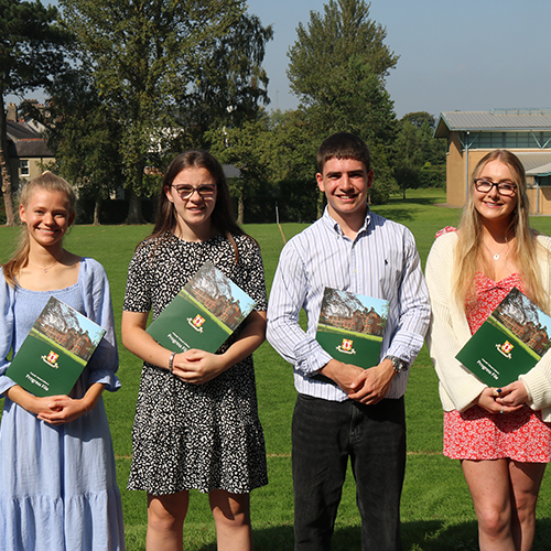 4 persons holding a brochure