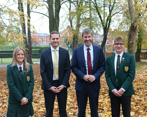 Students and pupils stood on leaves
